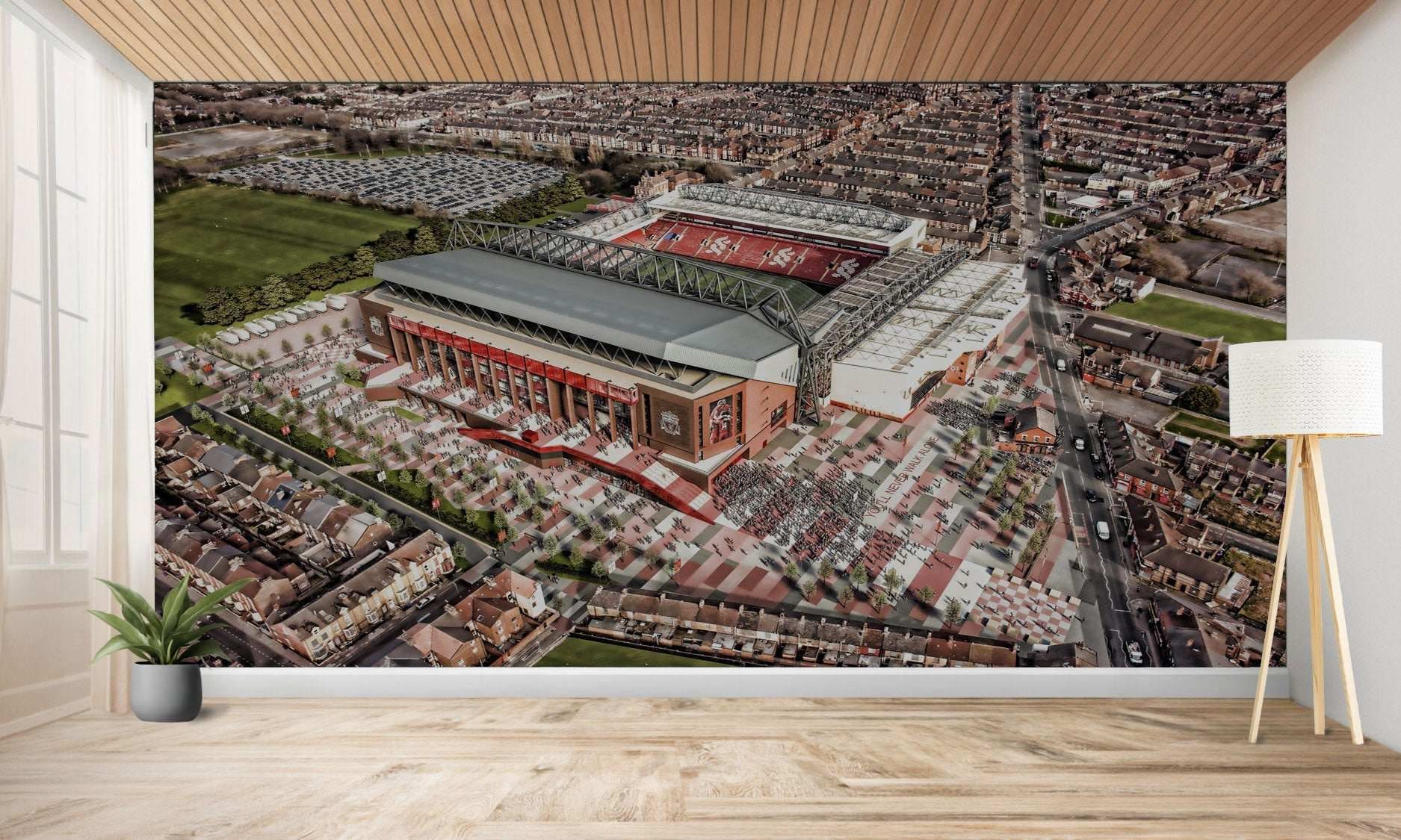 Vue aérienne d’un grand stade de football entouré d’un développement urbain.